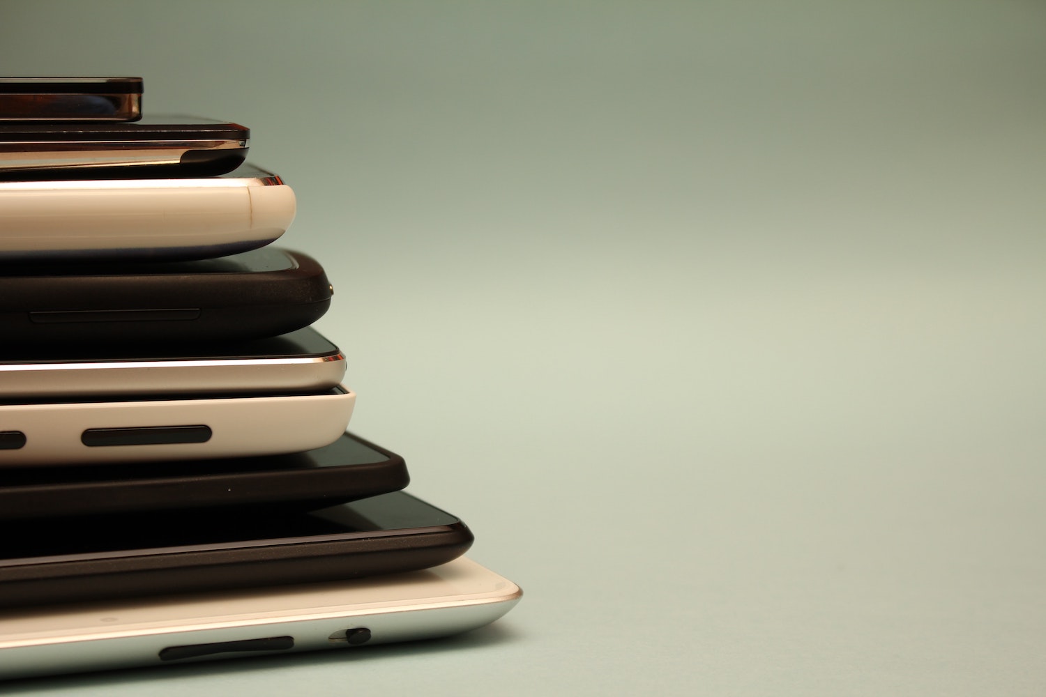  A couple of mobile phones stacked upon each other 
