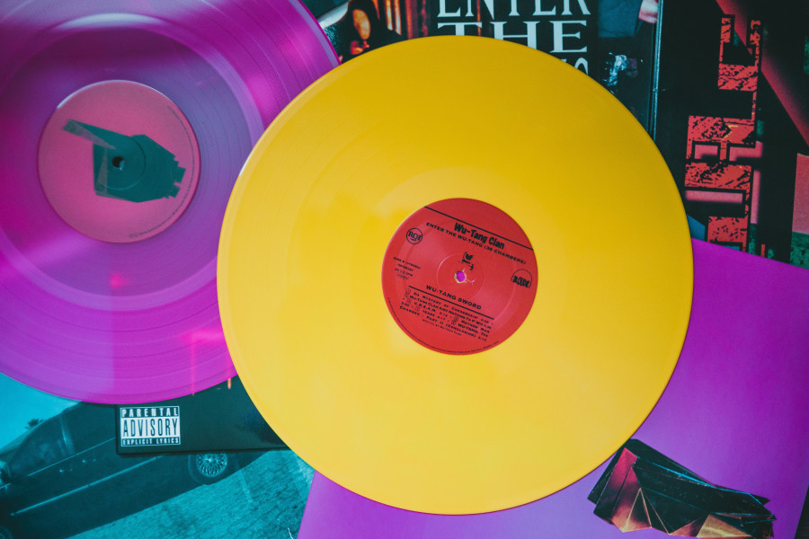  Two colorful vinyl LPs, one deep purple, the other bright yellow. You see the 